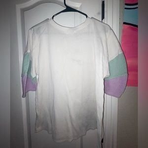 White, greenish, like dark lavender sleeve shirt.